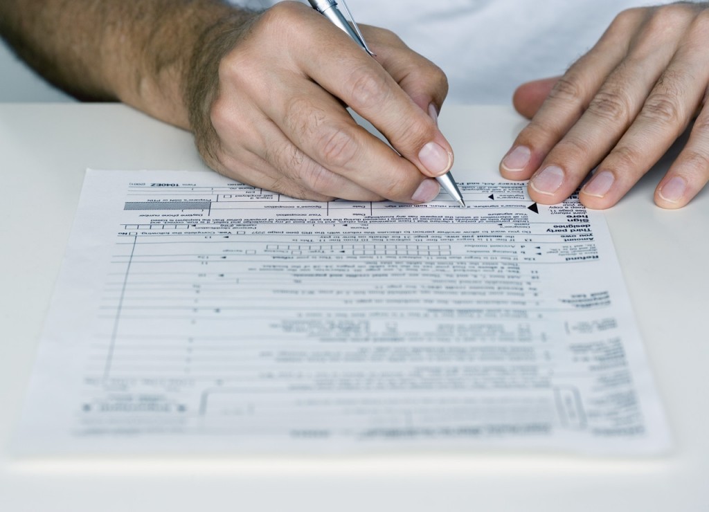 Man Filling out Tax Form